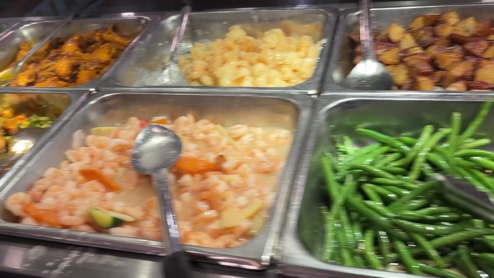 Buffet trays with Chinese dishes and sushi.