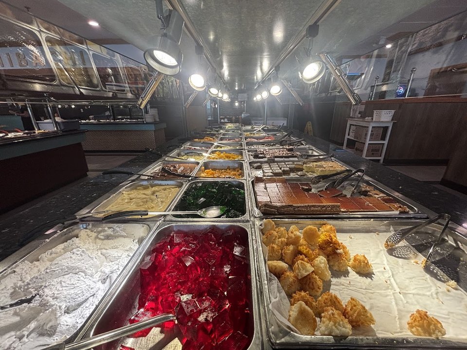 Rows of food pans on a buffet line.